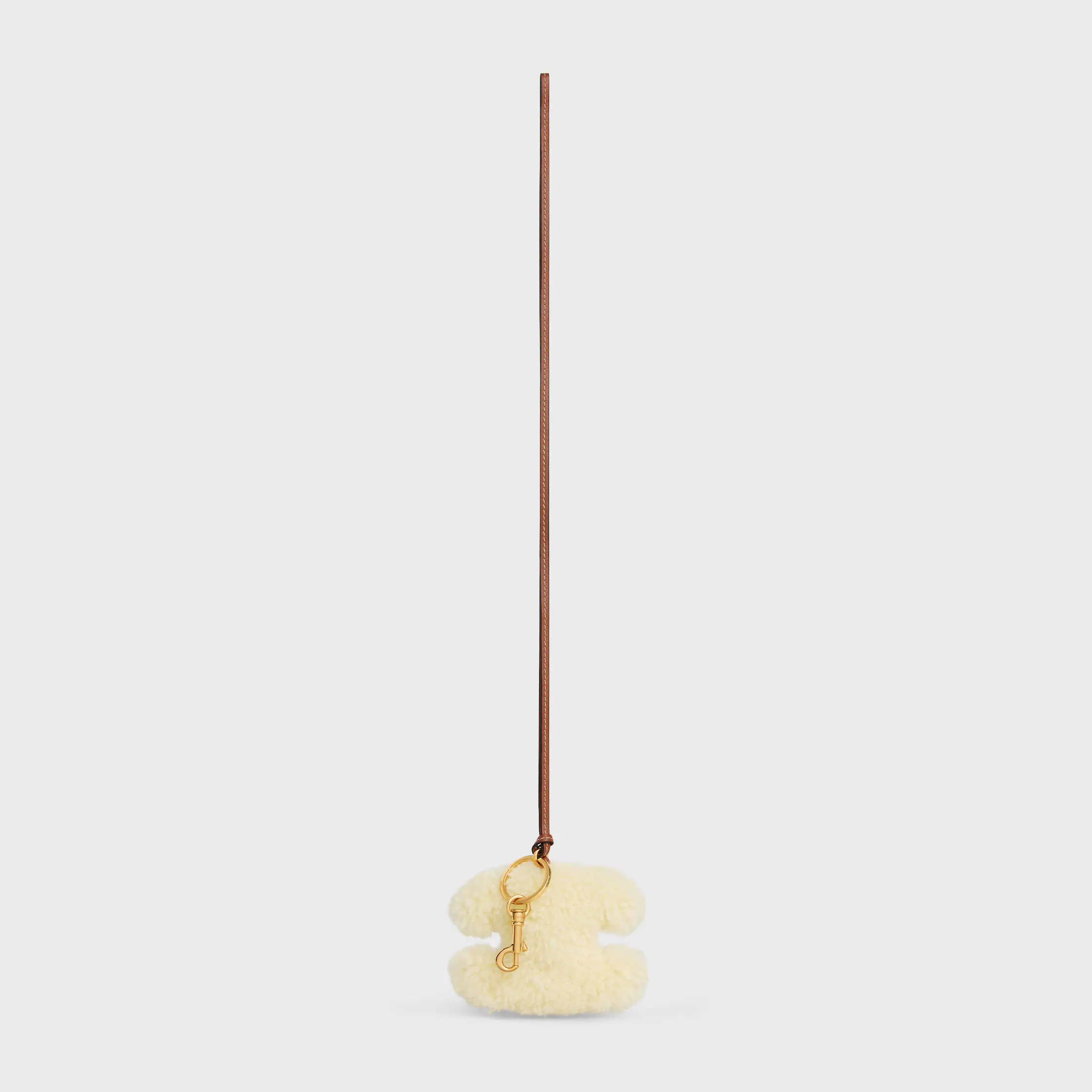 TRIOMPHE porte-clés pom-pom en PEAU DE VEAU DÉPOUILLÉE ET PEAU DE VEAU LISSE avec finition or